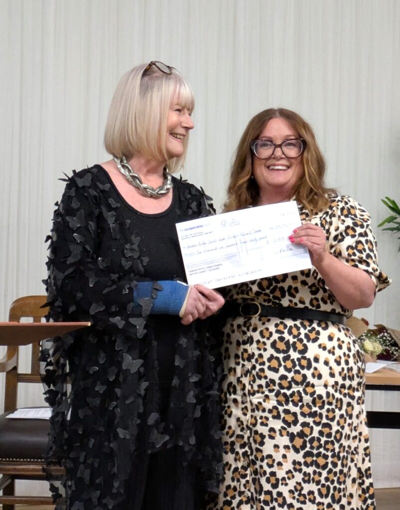 The outgoing Mayor, Councillor Pat Fraser, handing a cheque to a representative of her chosen charity, Hebden Bridge Saints under 15’s Girls Football Team.