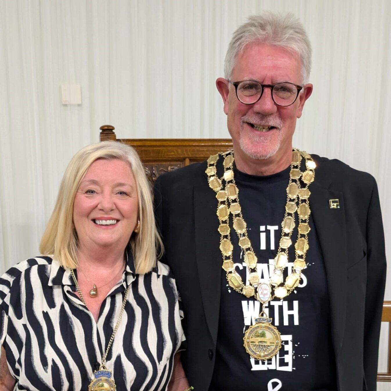 Photograph of the new Mayor, Councillor Keith Butterick wearing the Mayoral chains standing next to his wife and consort Lorna Butterick.