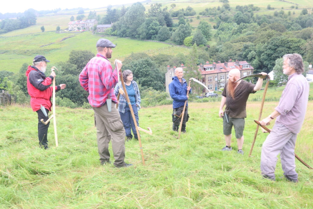A group of volunteers for the scything demonstration at Meadows Day 2026