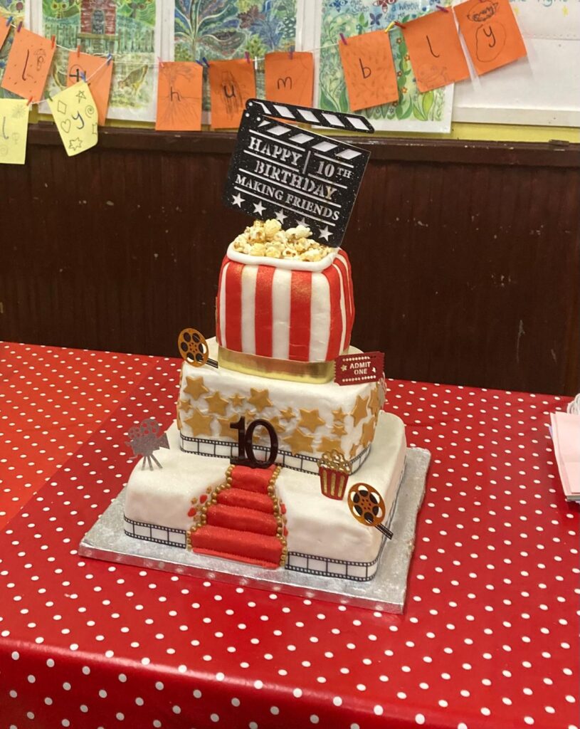 A birthday cake in the shape of a box of popcorn, to celebrate 10 years of the Making Friends project run by Friends of Hebden Bridge Picture House.